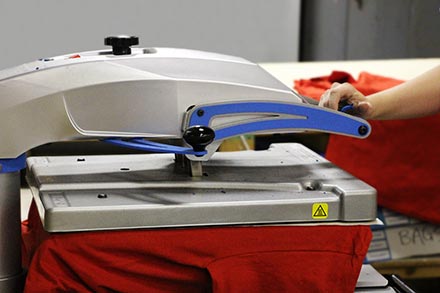 Heat press applying numbers for team uniforms